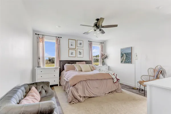 a living room with furniture a fireplace and a floor to ceiling window