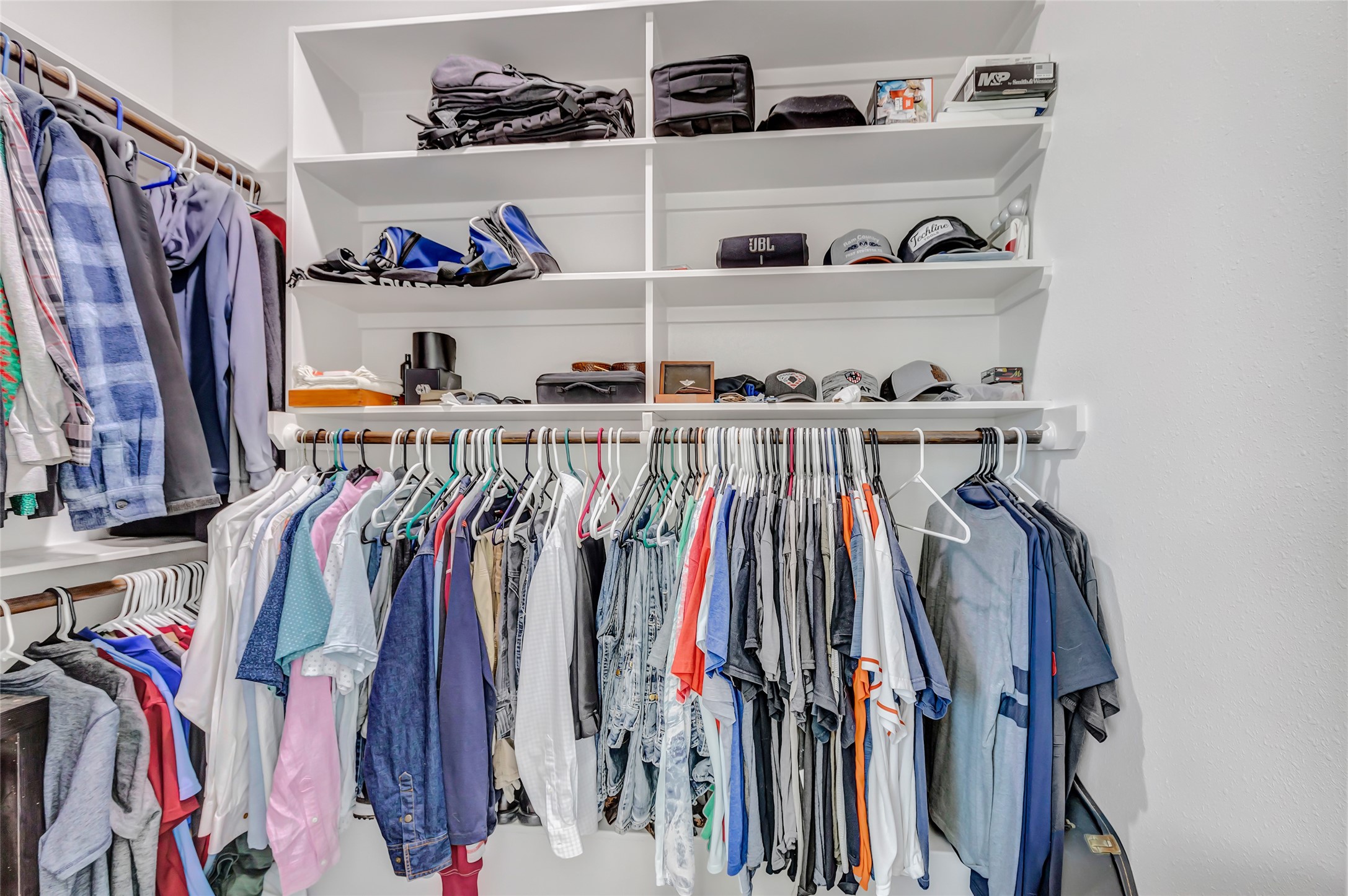 136 Timber Ridge Road Liberty, TX 77575 - Photo 27 of 50 a view of walk in closet with clothes