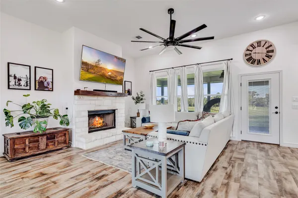 a living room with fireplace furniture and a flat screen tv