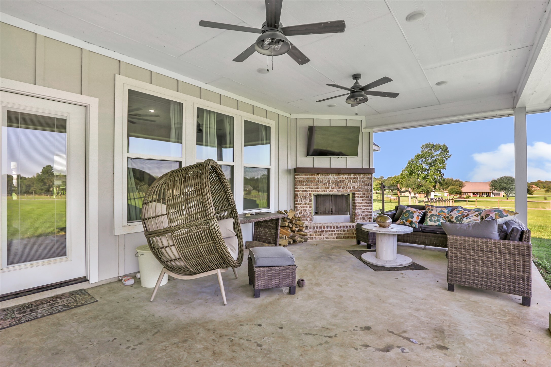 136 Timber Ridge Road Liberty, TX 77575 - Photo 34 of 50 a living room with furniture a fireplace and a floor to ceiling window