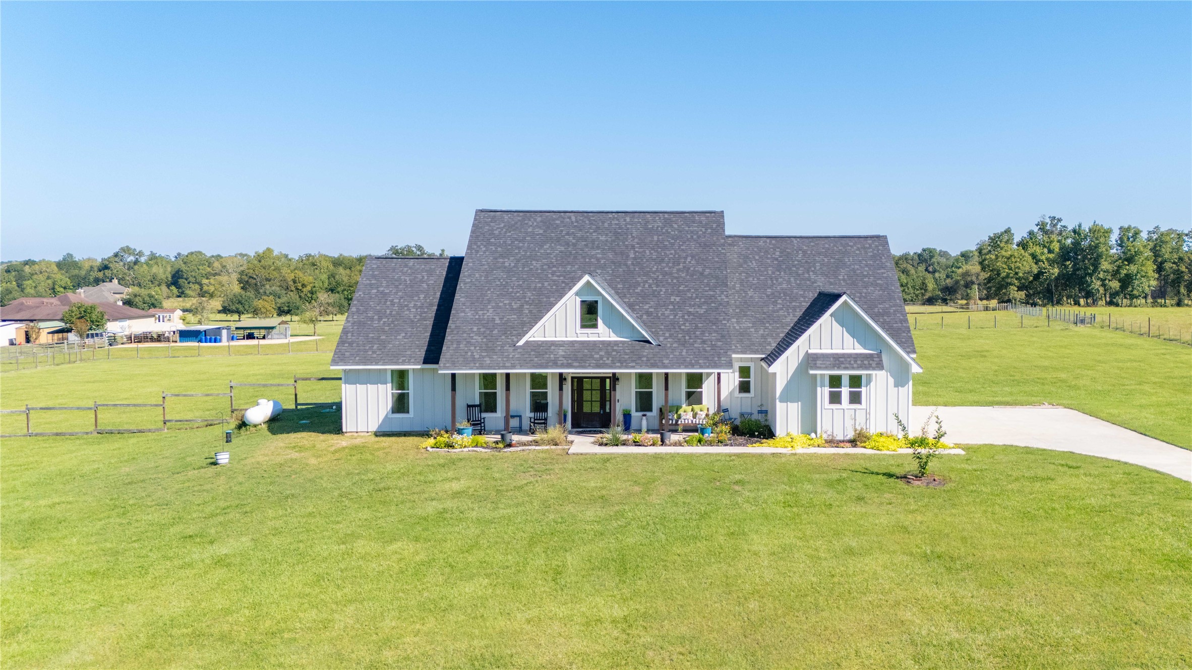 136 Timber Ridge Road Liberty, TX 77575 - Photo 37 of 50 a front view of a house with a yard table and chairs