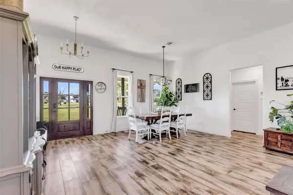 a living room with lots of furniture and a chandelier