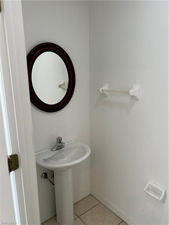 972 Hampton Circle, Unit 77 Naples, FL 34105 - Photo 20 of 24 a bathroom with a sink and a mirror