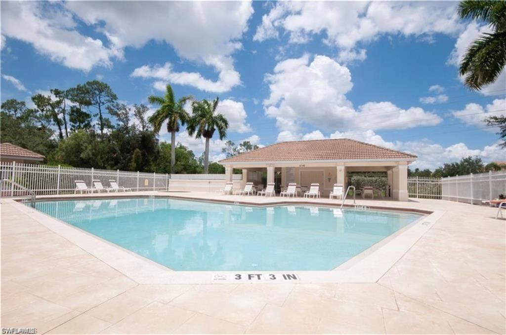 972 Hampton Circle, Unit 77 Naples, FL 34105 - Photo 21 of 24 a view of a swimming pool with a patio