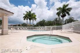 972 Hampton Circle, Unit 77 Naples, FL 34105 - Photo 22 of 24 a view of a swimming pool with a yard