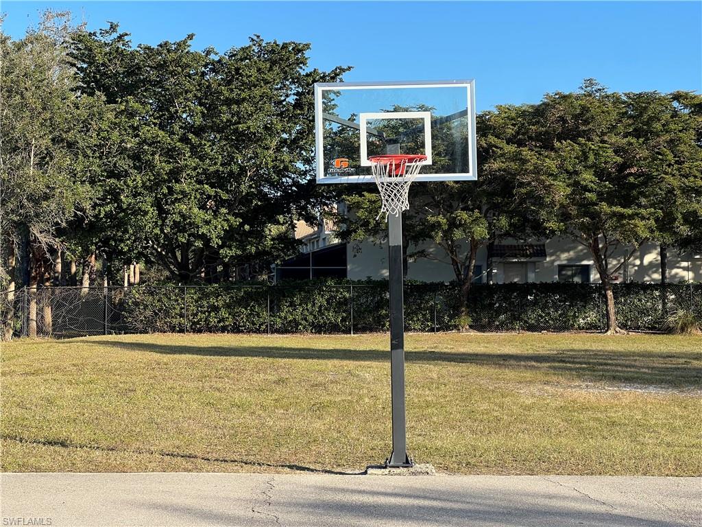 972 Hampton Circle, Unit 77 Naples, FL 34105 - Photo 23 of 24 a front view of a house with trees