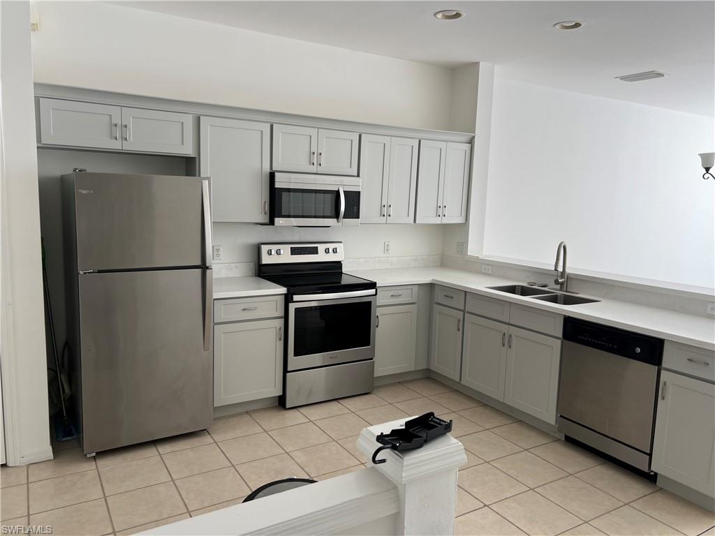 972 Hampton Circle, Unit 77 Naples, FL 34105 - Photo 5 of 24 a kitchen with cabinets stainless steel appliances and a counter space