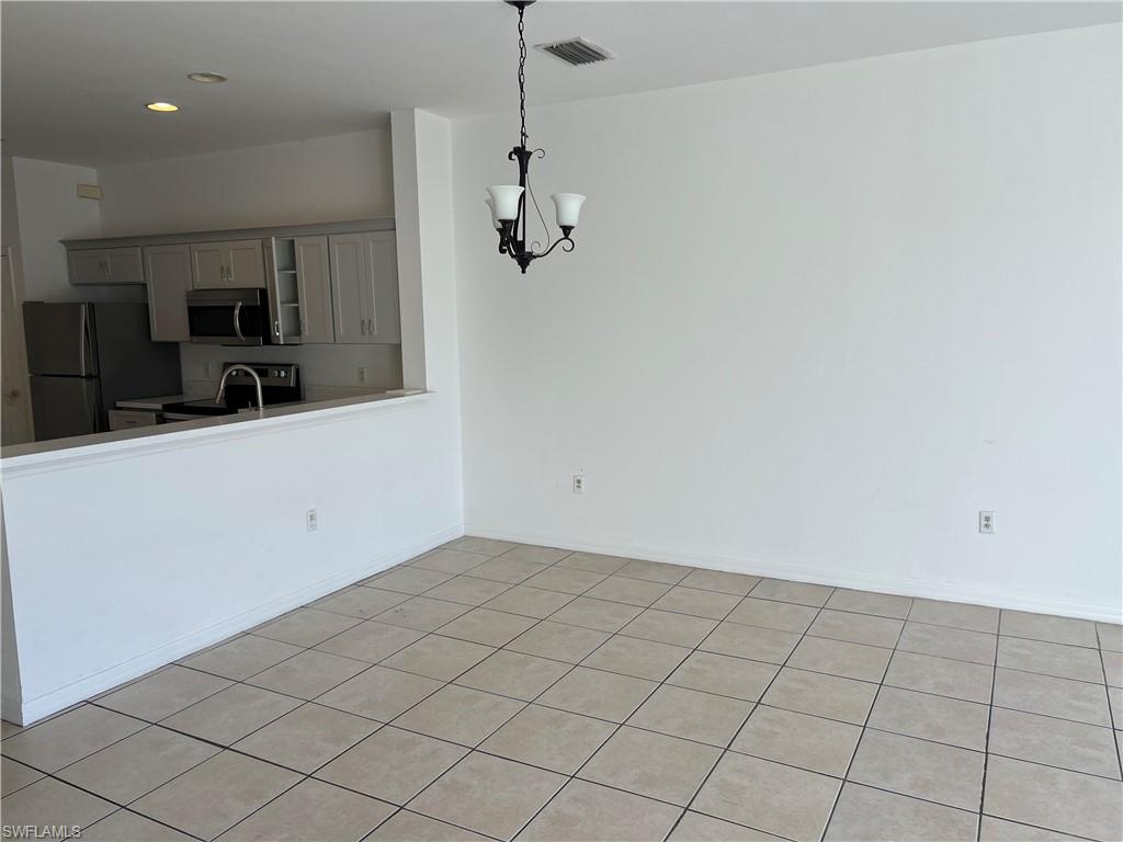 972 Hampton Circle, Unit 77 Naples, FL 34105 - Photo 8 of 24 a view of a kitchen with a sink and dishwasher