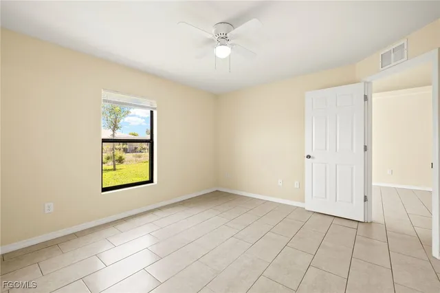 an empty room with windows and closet