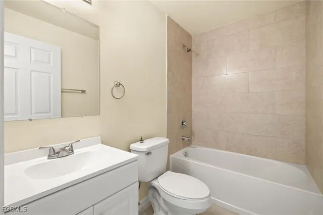 a bathroom with a sink toilet vanity and shower