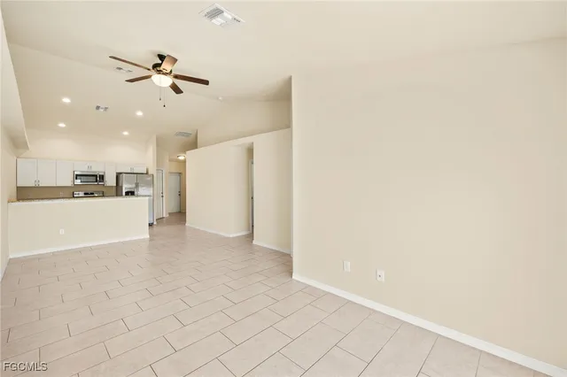 a view of a kitchen with a sink and a refrigerator