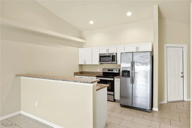 a kitchen with stainless steel appliances a refrigerator sink and stove
