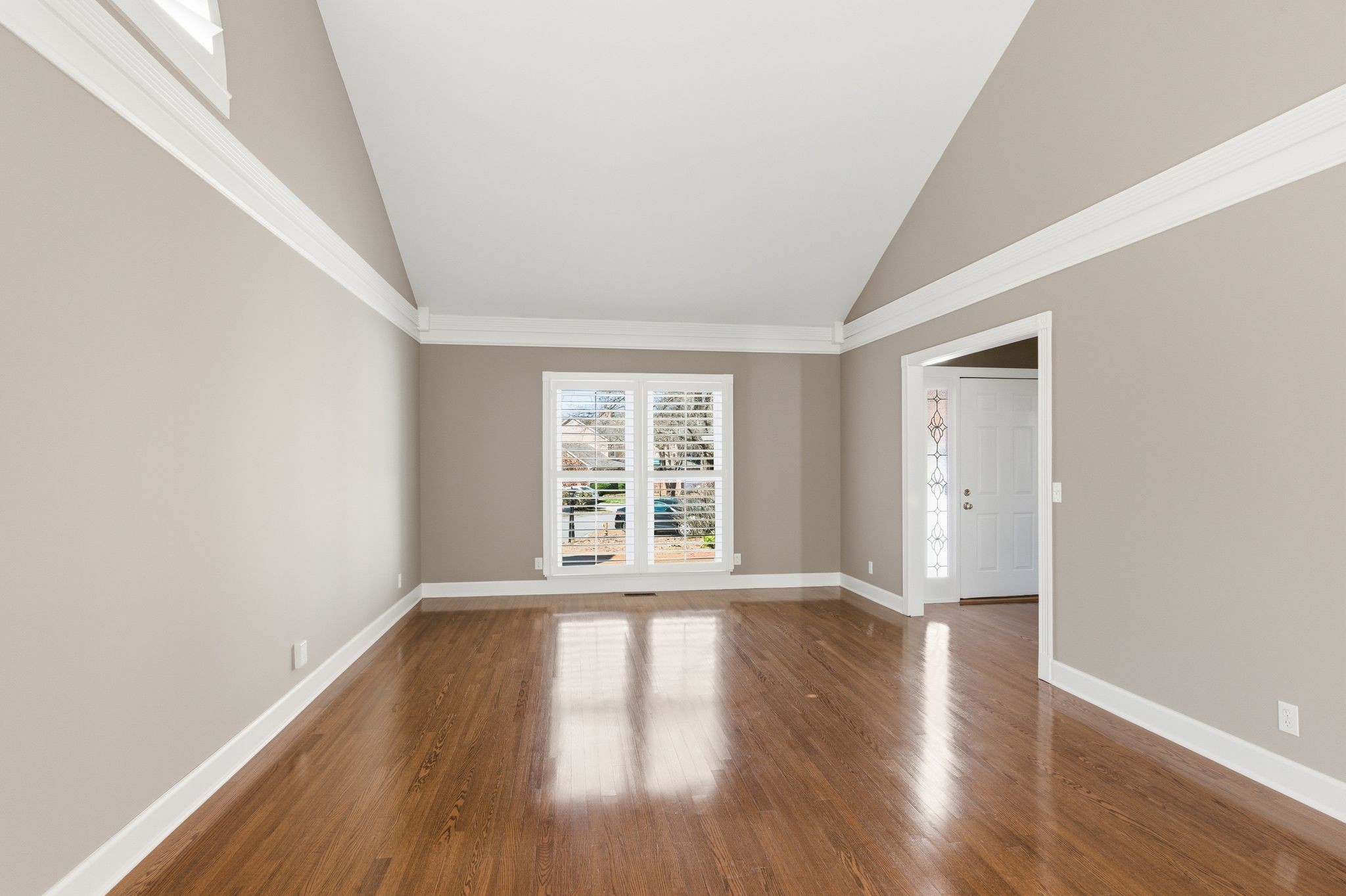 202 Bramley Place Franklin, TN 37069 - Photo 7 of 32 a view of an empty room with wooden floor and a window