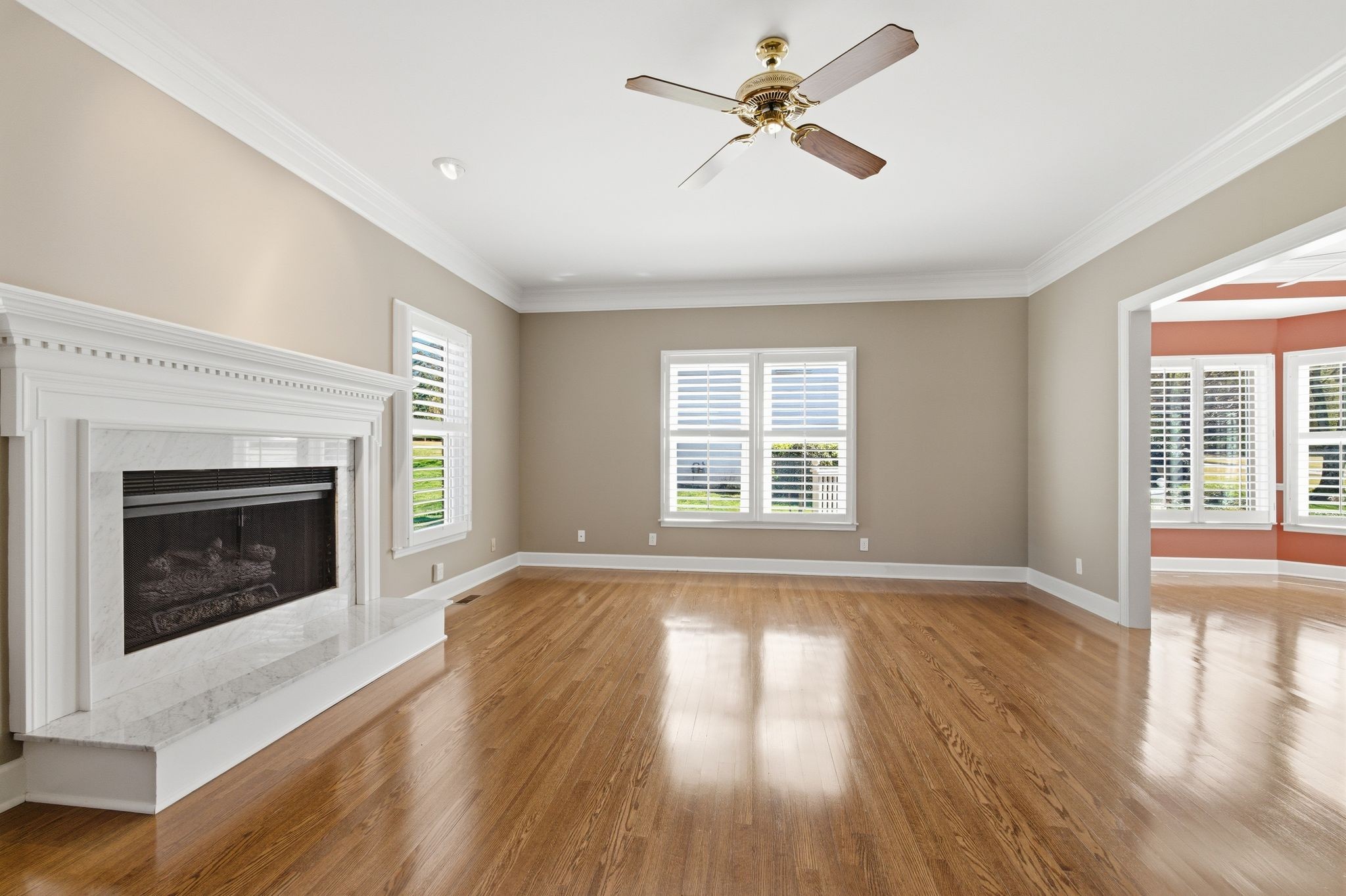 202 Bramley Place Franklin, TN 37069 - Photo 10 of 32 a view of an empty room with wooden floor fireplace and a window