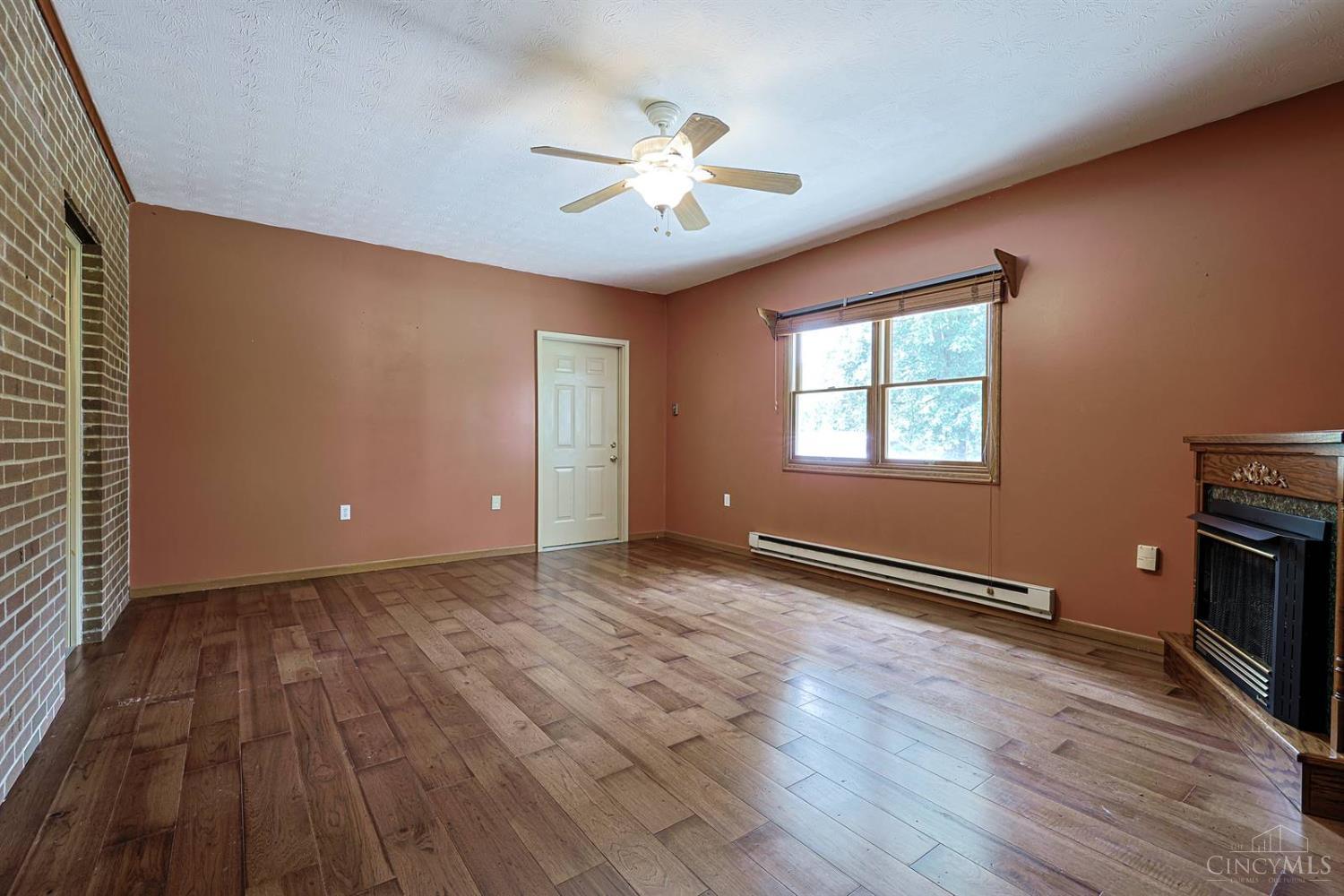4617 Graybill Road Georgetown, OH 45121 - Photo 23 of 58 This Flex Room Features A Gas Fireplace And Could Be Used As A Family Room, Formal Dining Room Or Even a Huge Fourth Bedroom. It's Large Enough To Fit Into Any Plan You Have For Your New Home! The Exposed Brick Walls Add A Layer Of Warmth And Character That Is Hard To Find In Many Homes.