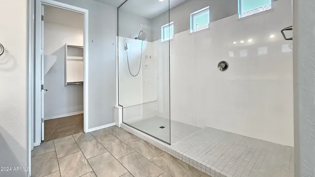 a bathroom with a glass shower door and a shower