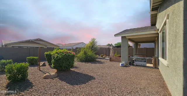 a outdoor space with the couches and dining table with the garden view