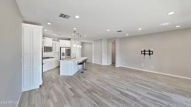 a view of a kitchen and dining room with a wooden floor