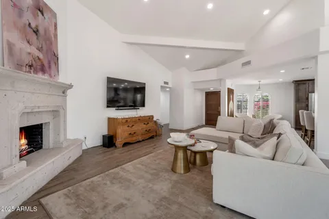 a living room with furniture and a large mirror