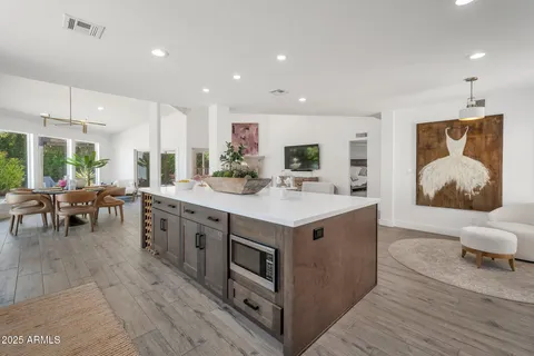 a kitchen with sink stove and cabinets