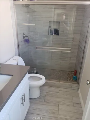 a bathroom with a toilet and a shower