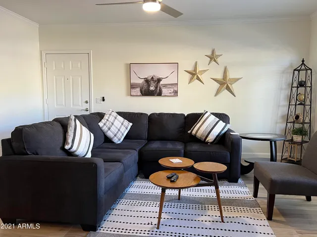 a living room with furniture a fireplace and a flat screen tv