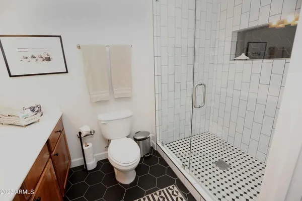 a bathroom with a toilet a sink and mirror