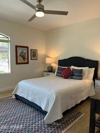 a living room with furniture a rug and a window
