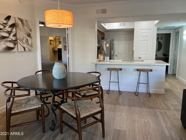 a bedroom with a large bed and flat tv screen on dresser
