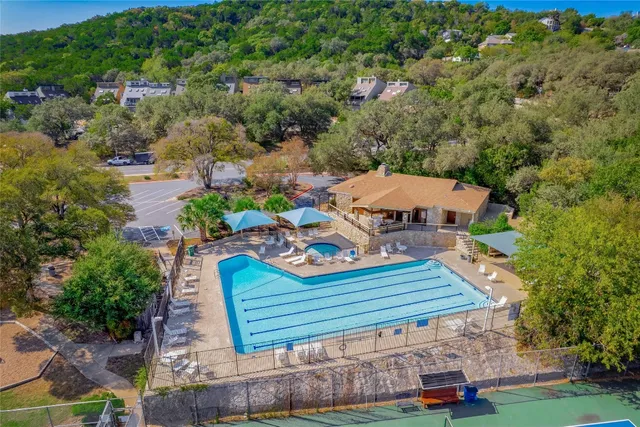 a view of a backyard with swimming pool