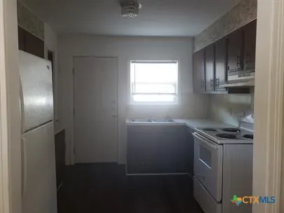 a kitchen with cabinets and a stainless steel appliances