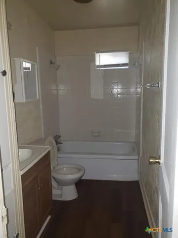 a bathroom with a toilet a sink and bathtub
