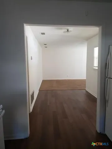 an empty room with wooden floor