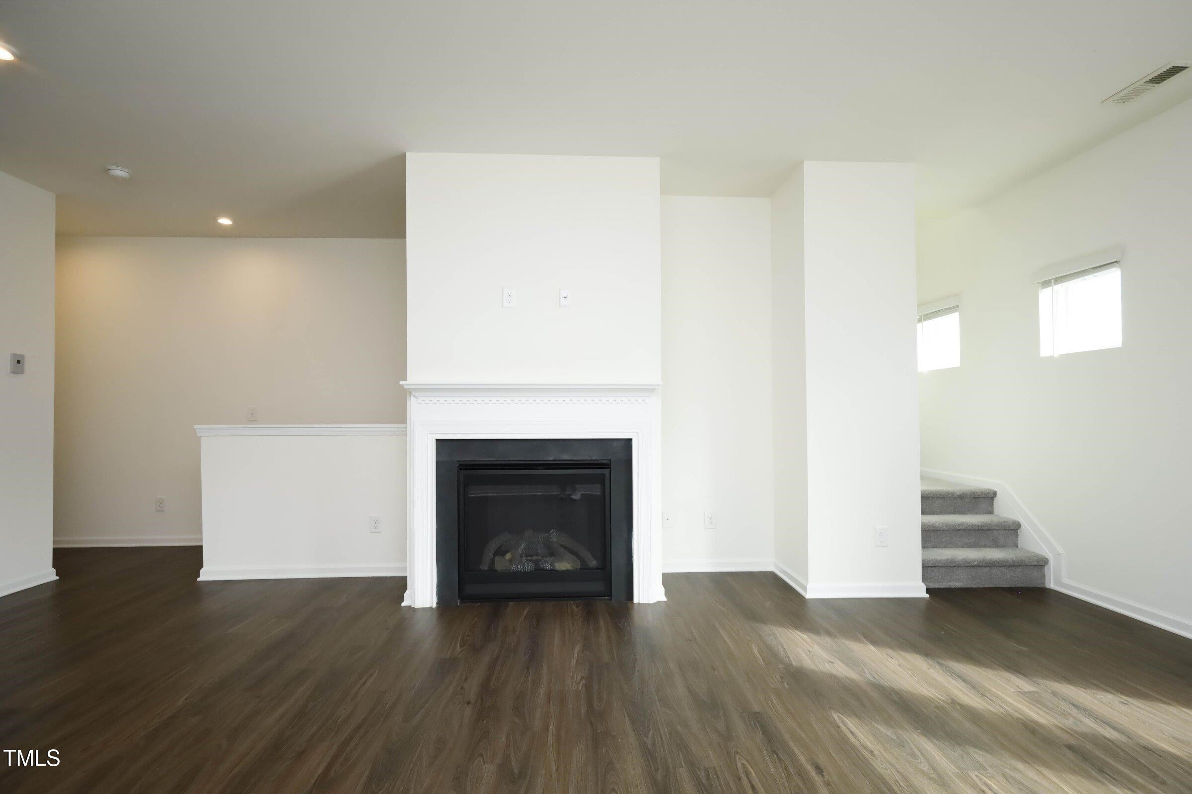 4121 Mahal Avenue Cary, NC 27519 - Photo 14 of 33 a view of empty room with wooden floor and fireplace