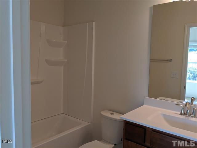 4121 Mahal Avenue Cary, NC 27519 - Photo 18 of 33 a bathroom with a sink a toilet and shower