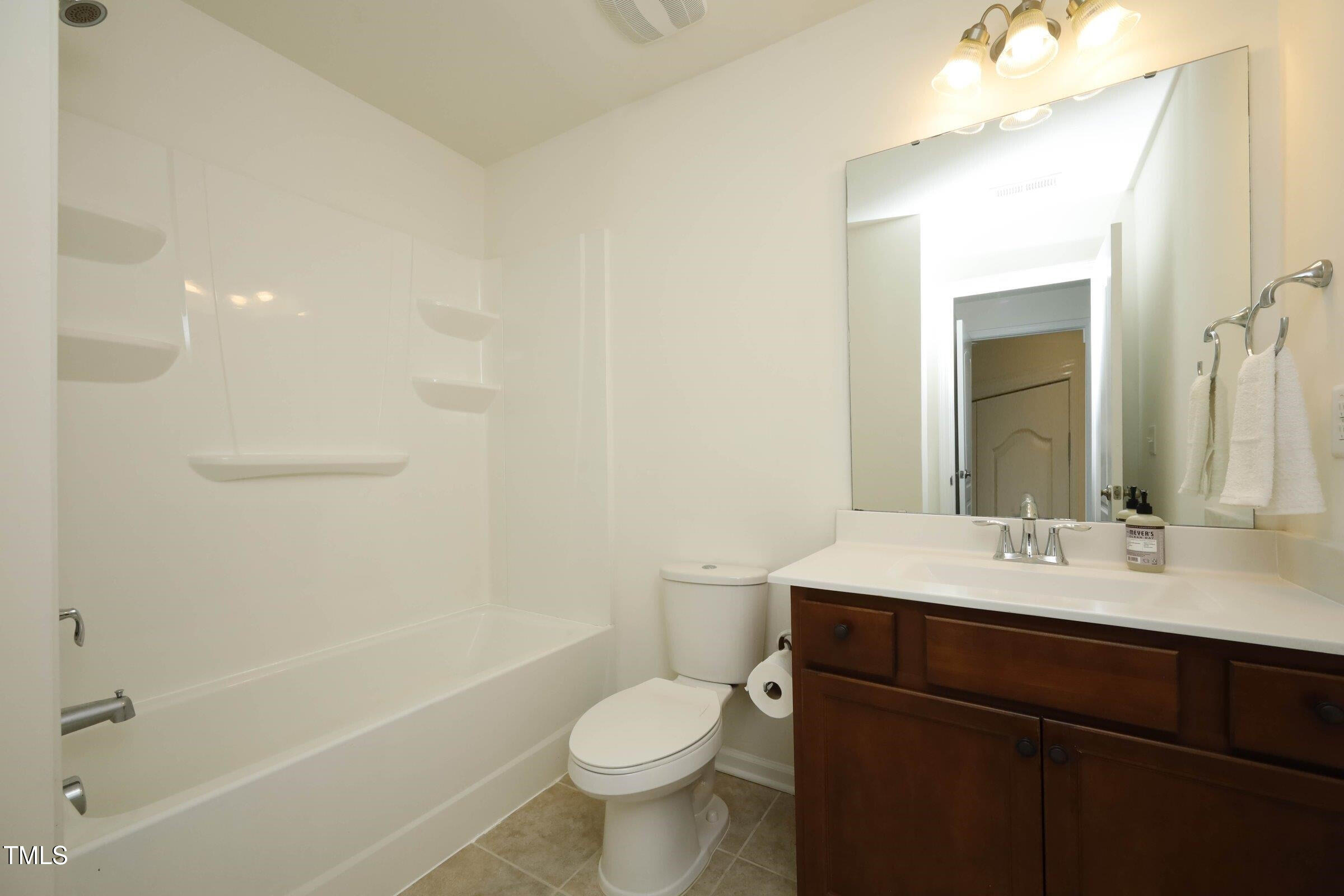 4121 Mahal Avenue Cary, NC 27519 - Photo 19 of 33 a bathroom with a sink a toilet and shower