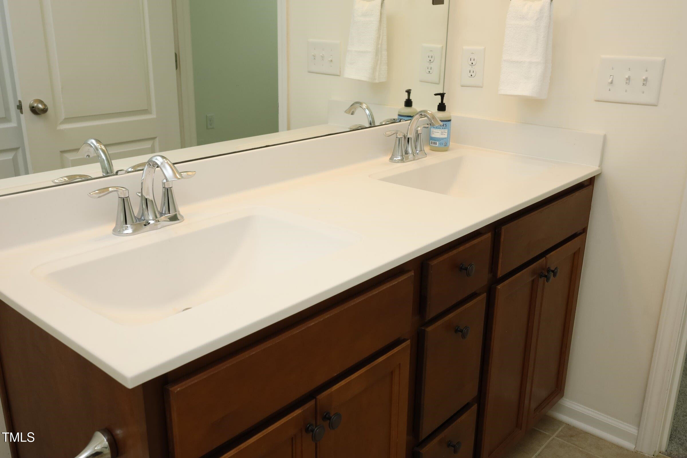 4121 Mahal Avenue Cary, NC 27519 - Photo 21 of 33 a bathroom with a sink and a mirror