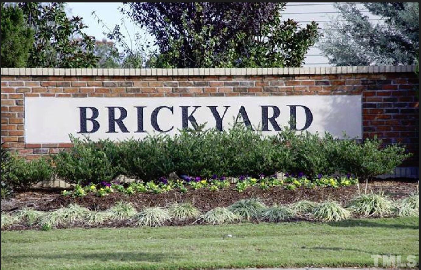 4121 Mahal Avenue Cary, NC 27519 - Photo 33 of 33 a street sign on a wall next to a yard