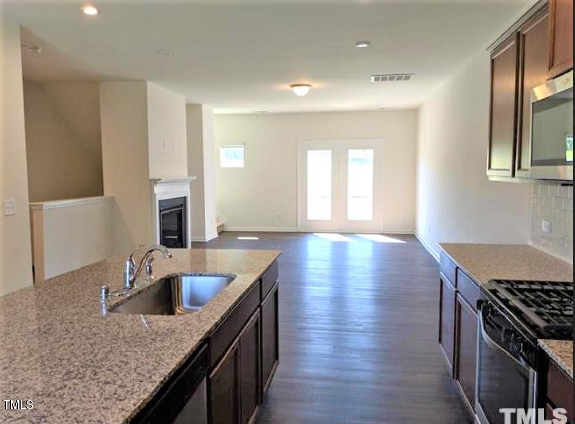 4121 Mahal Avenue Cary, NC 27519 - Photo 7 of 33 a kitchen with sink a stove and cabinets
