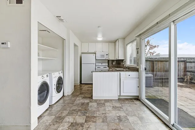 a kitchen with refrigerator and cabinets