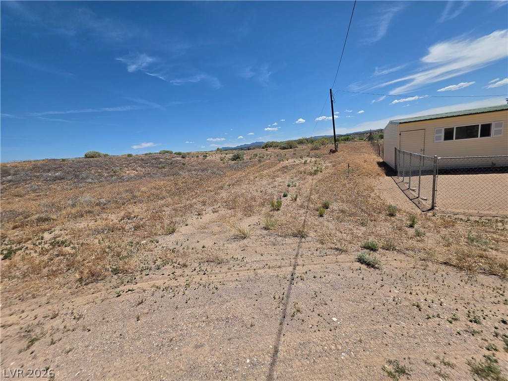 2930 Frehner Ranch Road Pioche, NV 89043 - Photo 20 of 39 A spacious, undeveloped desert lot awaits your vision, complete with an existing structure and expansive sky.