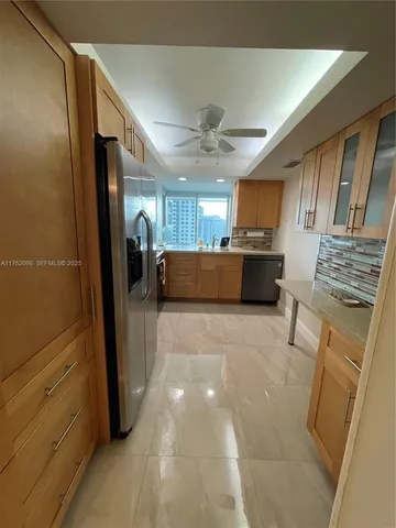 a kitchen with stainless steel appliances granite countertop a refrigerator and a sink