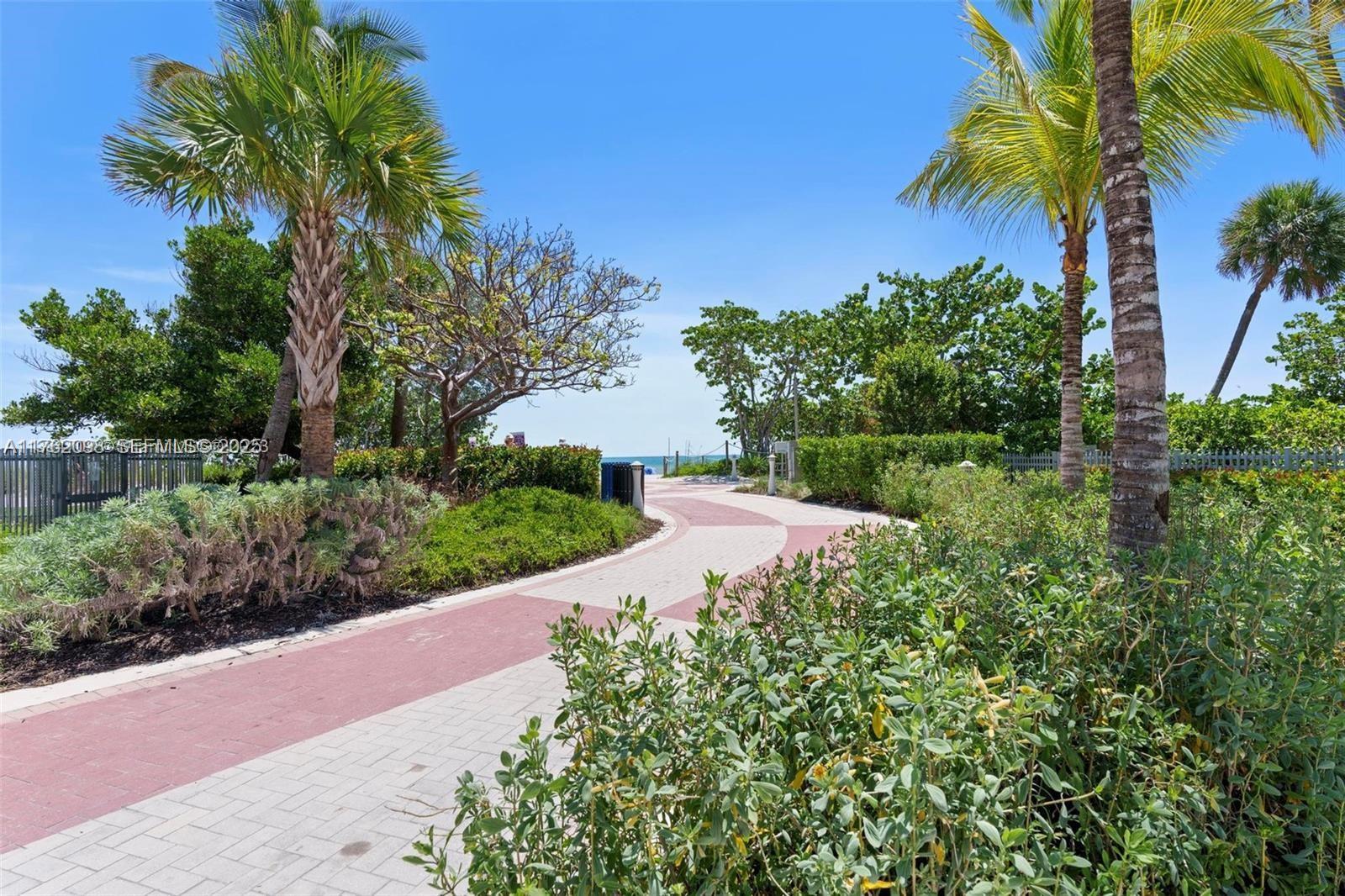 2655 Collins Avenue, Unit 1906 Miami Beach, FL 33140 - Photo 23 of 35 a view of a garden with a building in the background