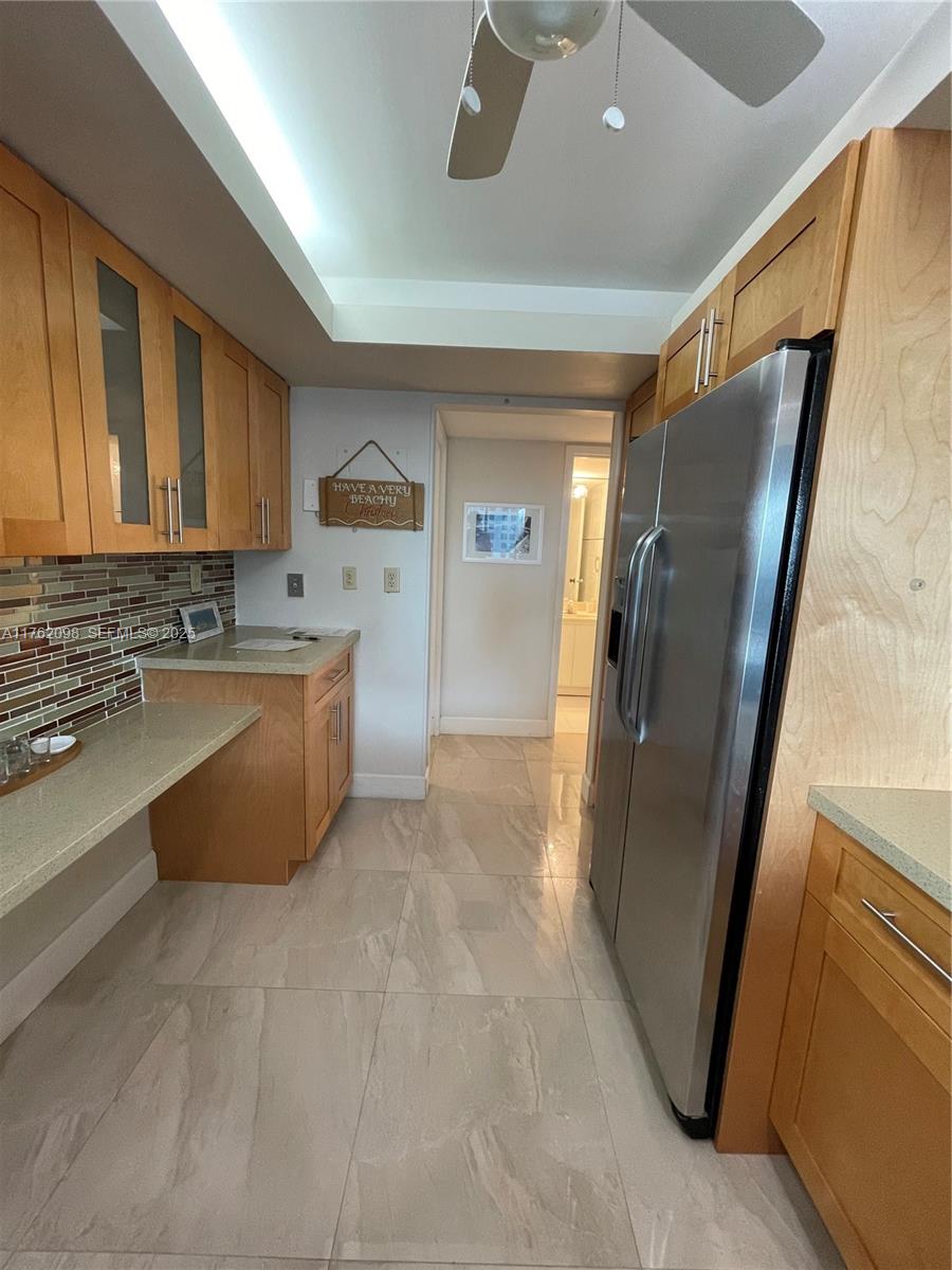 2655 Collins Avenue, Unit 1906 Miami Beach, FL 33140 - Photo 3 of 35 a kitchen with stainless steel appliances granite countertop a refrigerator and a sink