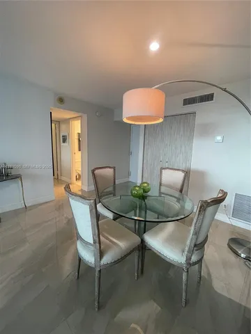 a view of hallway with cabinets and wooden floor