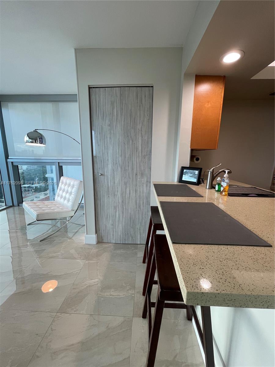 2655 Collins Avenue, Unit 1906 Miami Beach, FL 33140 - Photo 8 of 35 Bar stool\ kitchen area