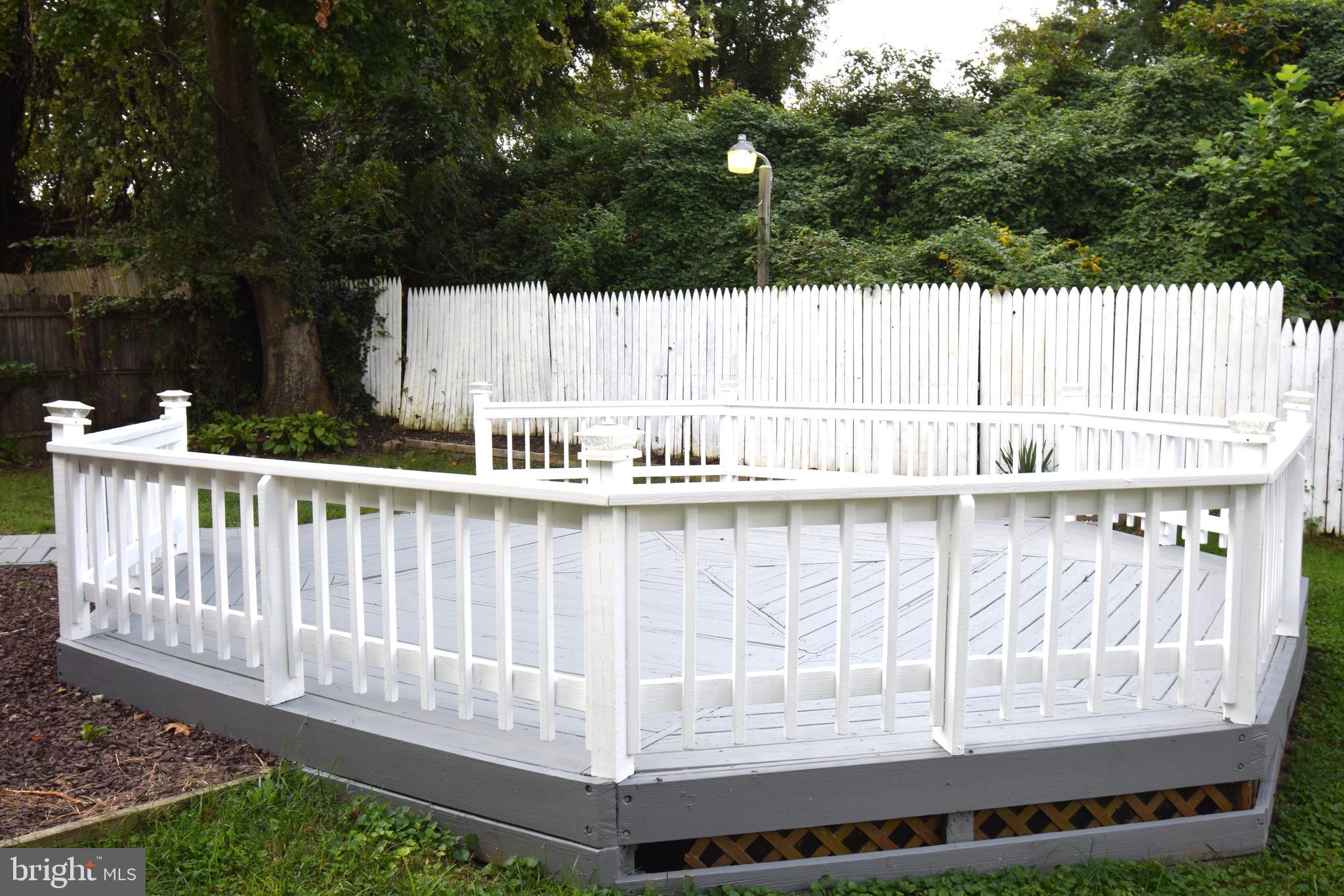 1354 Sudvale Road Pikesville, MD 21208 - Photo 3 of 17 a view of a wooden deck and a yard