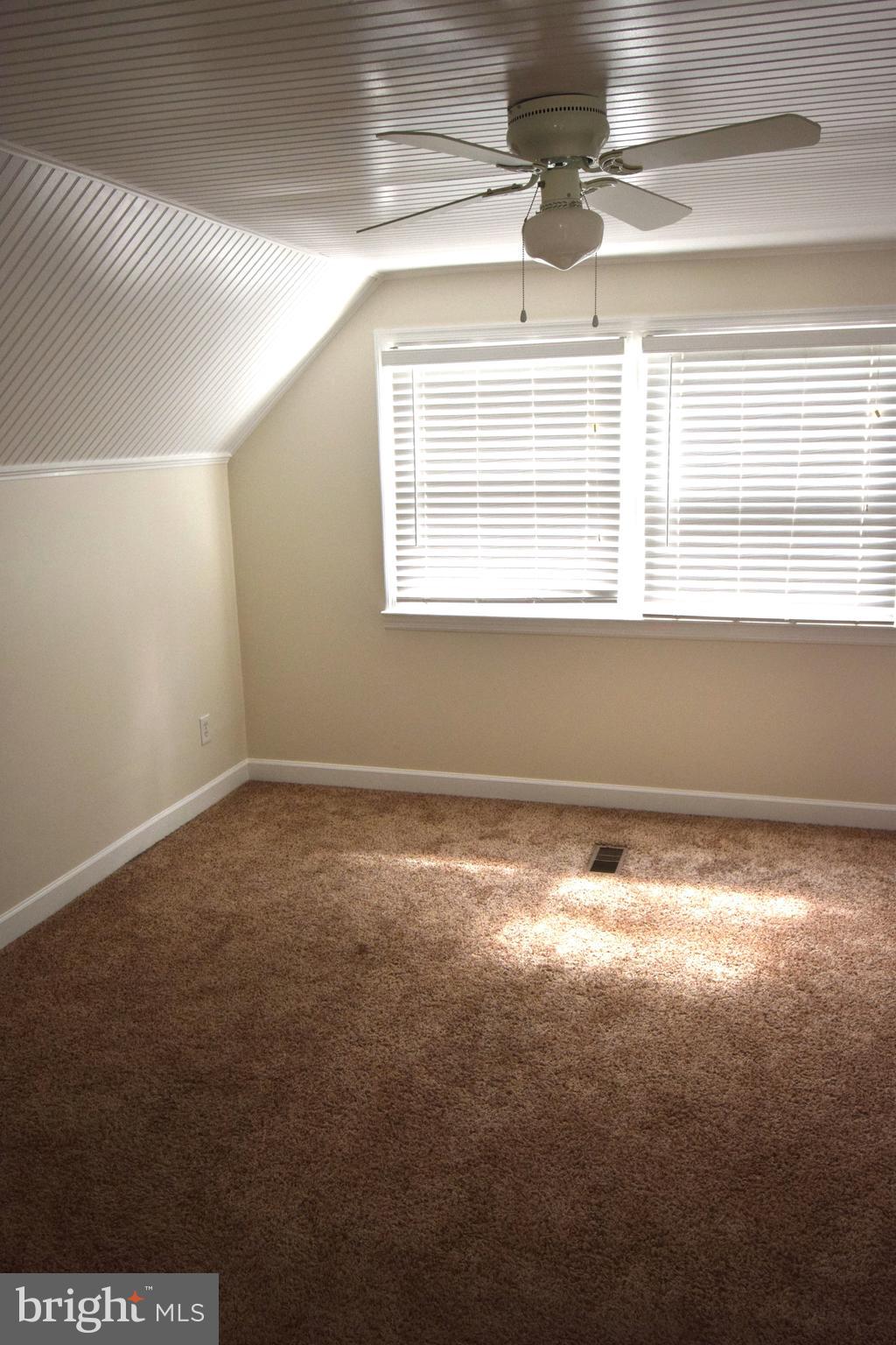 1354 Sudvale Road Pikesville, MD 21208 - Photo 10 of 17 a view of an empty room with a window