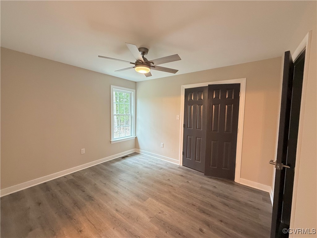 26 Tupelo Street Deltaville, VA 23043 - Photo 12 of 38 a view of an empty room with wooden floor and a window