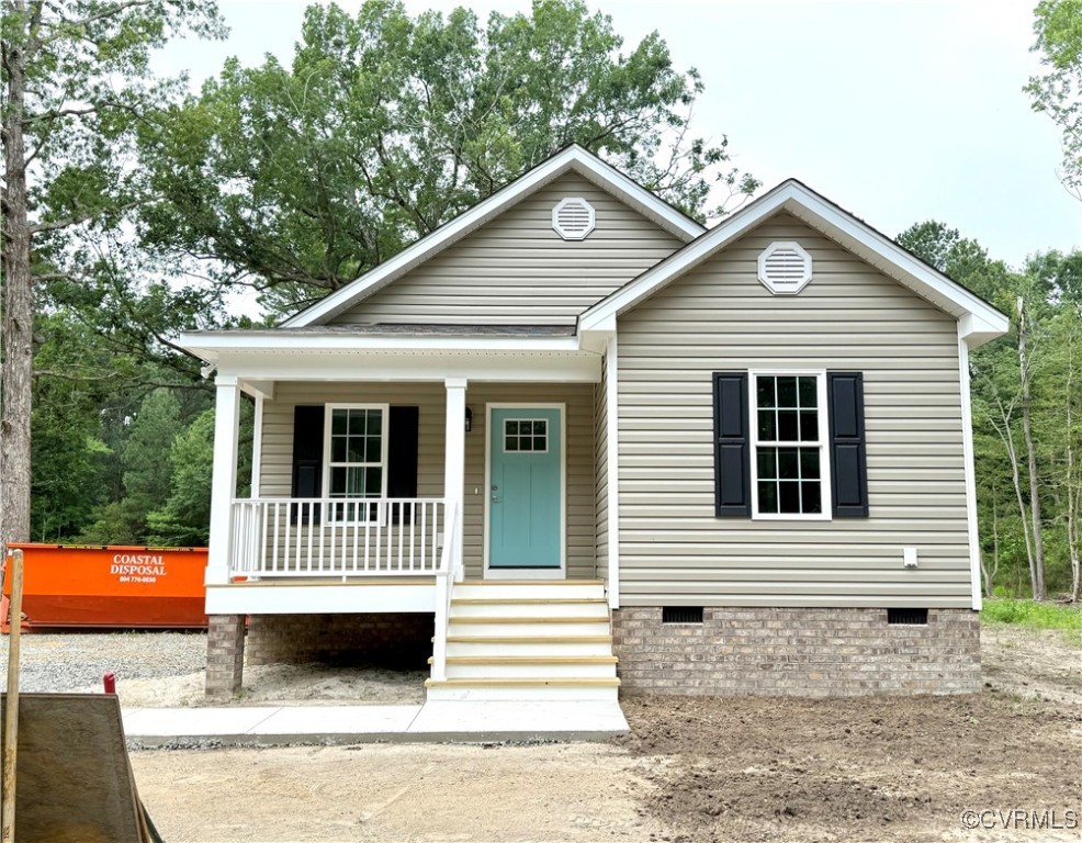 26 Tupelo Street Deltaville, VA 23043 - Photo 2 of 38 a front view of a house with a garden